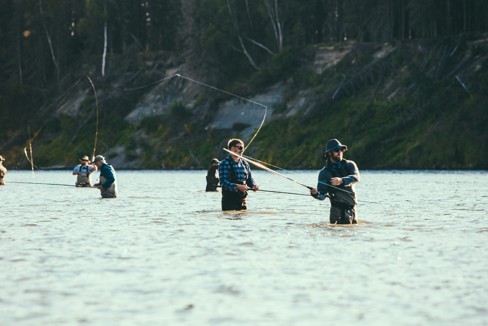 People on a boat fishing on a lake during the day